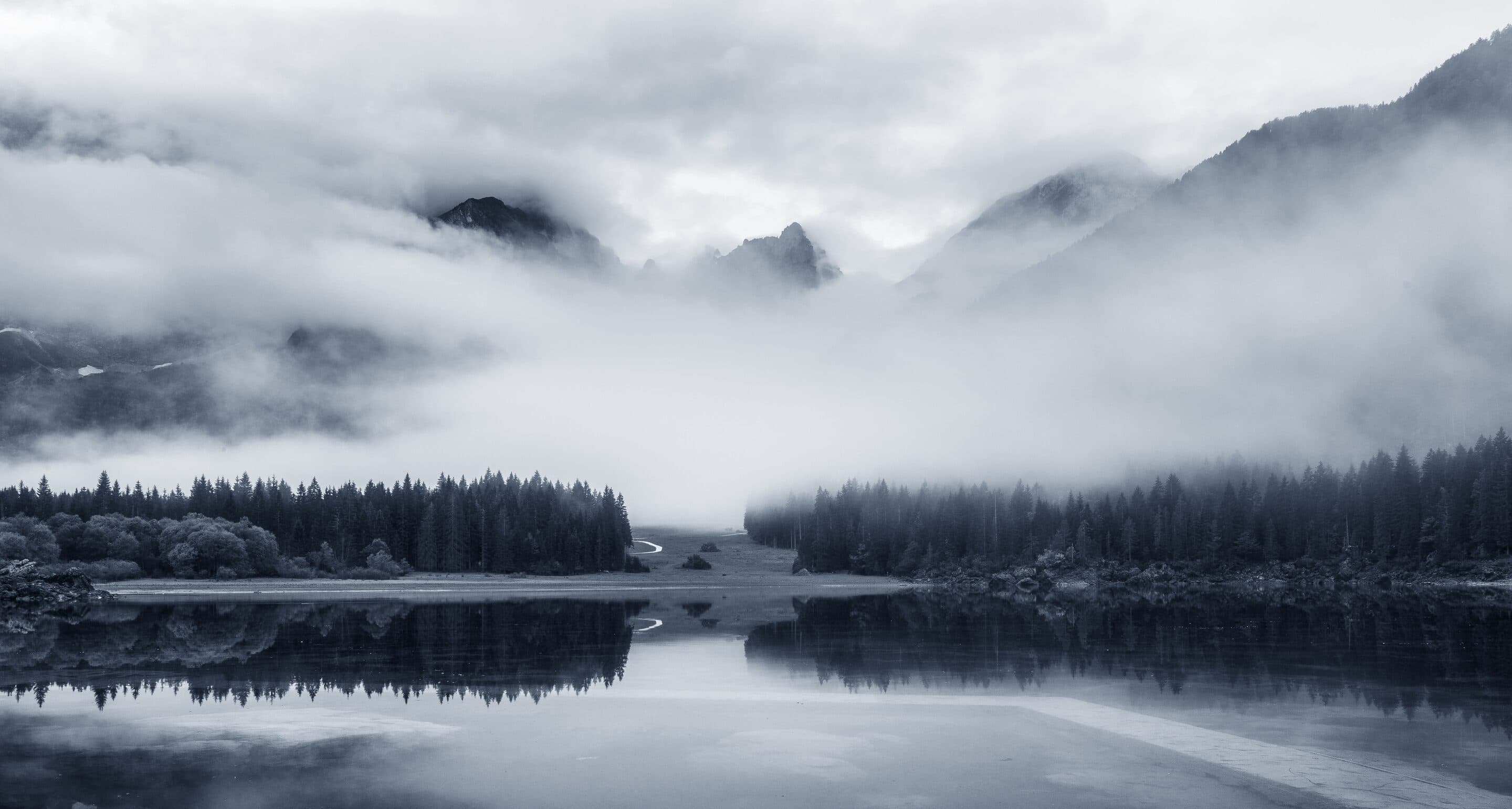 A forest lake under low cloud